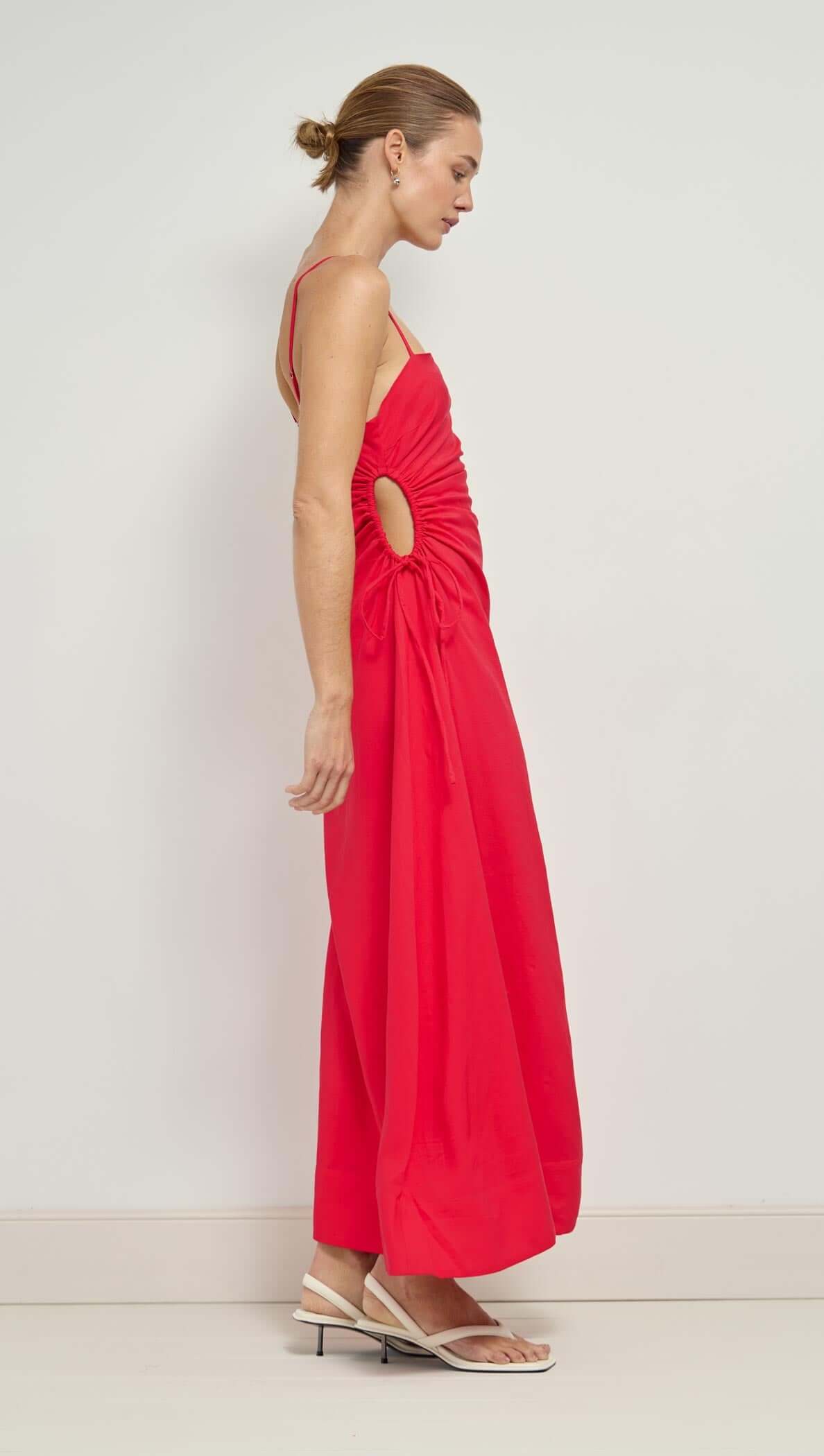 Red Linen Blend Cut-Out Maxi Dress featuring a side view of a model wearing a ruched design and waist cut-out.