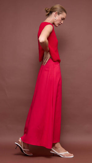 Woman wearing a Red Linen Blend Maxi Skirt with a high-waisted fit, paired with a red top and sandals.