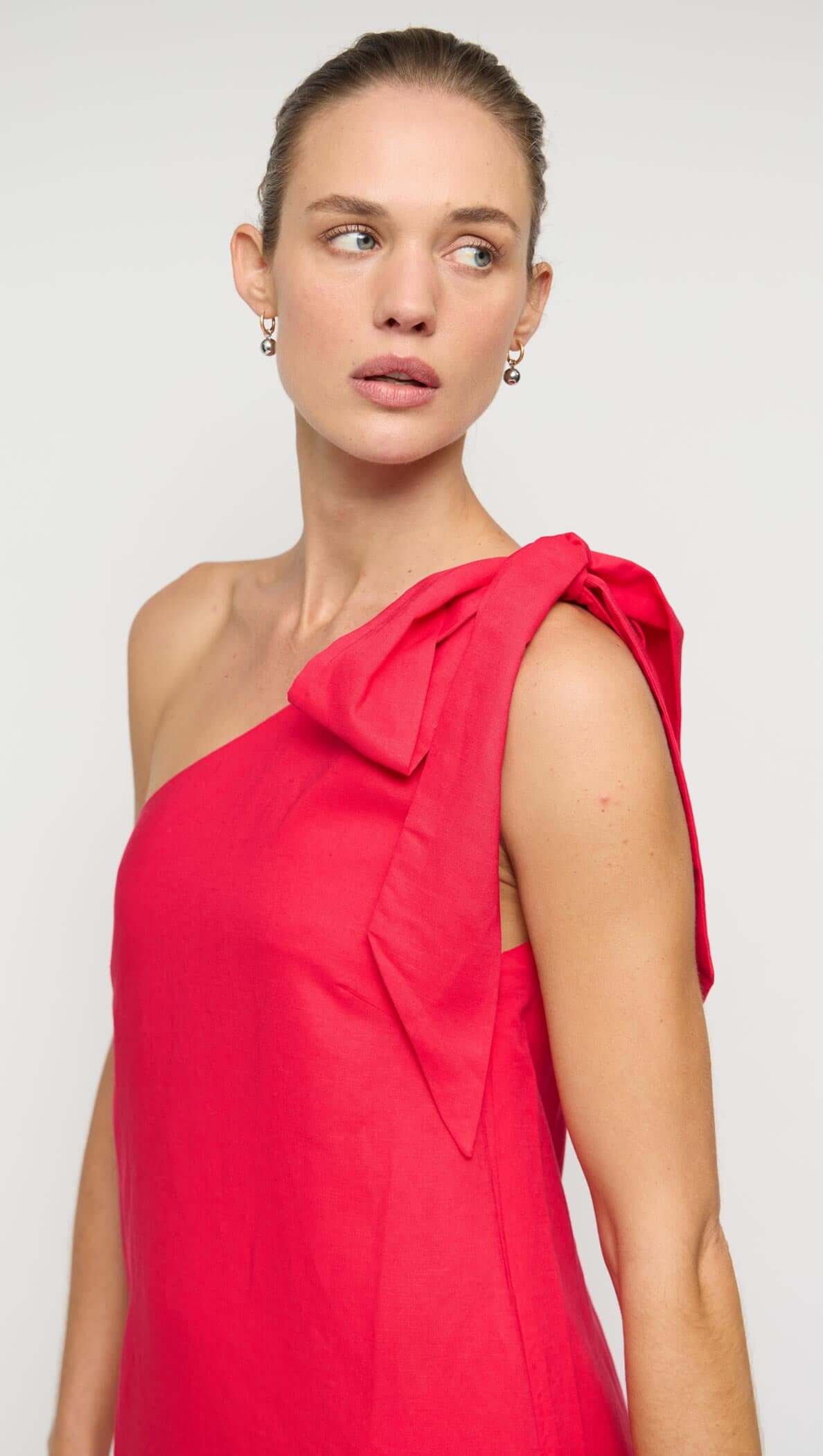 Red Linen Blend One Shoulder Mini Dress featuring a stylish oversized bow on the shoulder and a relaxed silhouette.