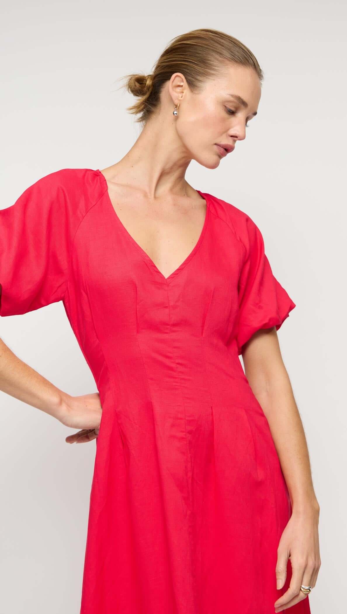 Red Linen Blend v-Neck Midi Dress modeled by a woman, showcasing short puff sleeves and a relaxed midi skirt.