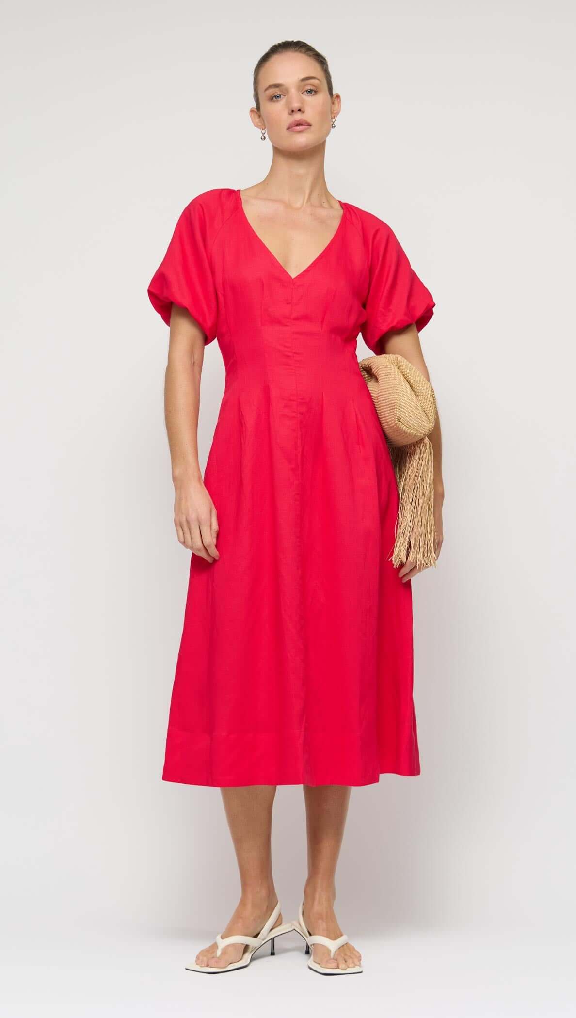 Red Linen Blend v-Neck Midi Dress modeled by a woman, showcasing short puff sleeves and a relaxed midi skirt.