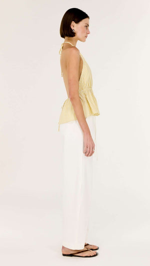 Butter Yellow Low Back Striped Halter Top displayed on a model, showcasing the side profile and flattering fit.