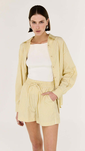Butter Yellow Striped Shorts worn with a light top and matching striped shirt, perfect for summer styling.
