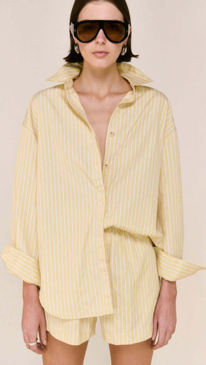 Model wearing a Butter Yellow Striped Shirt with sunglasses, showcasing a relaxed fit and subtle stripe detailing.