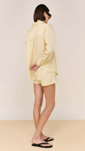 Model wearing a Butter Yellow Striped Shirt, showcasing the relaxed style and soft drape of the fabric from behind.
