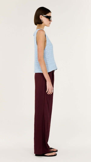 Model wearing the Baby Blue Cotton Knit Tank paired with wide-leg burgundy pants, showcasing a modern warm-weather look.