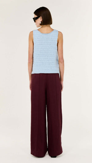 Model wearing a Baby Blue Cotton Knit Tank paired with wide-leg burgundy pants, showcasing a relaxed silhouette.