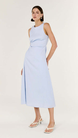 Baby Blue Cotton Textured Cut Out Midi Dress modeled by a woman, featuring a sleeveless design and subtle side cut-out.