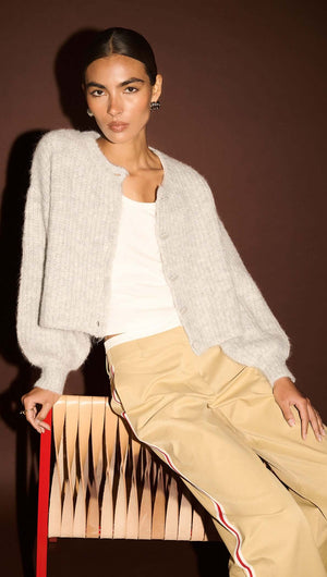 Model showcasing Beige Striped Contrast Waist Pants with a light gray cropped cardigan.