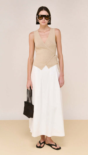 Model wearing a Beige V-neck Wrap Knit Top paired with a white skirt, showcasing a chic summer look.