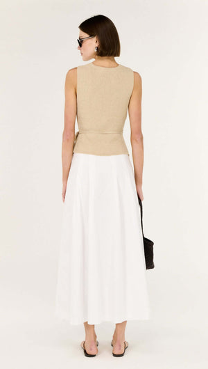 Beige V-neck Wrap Knit Top worn with a white skirt, showcasing its elegant back design and flattering fit.