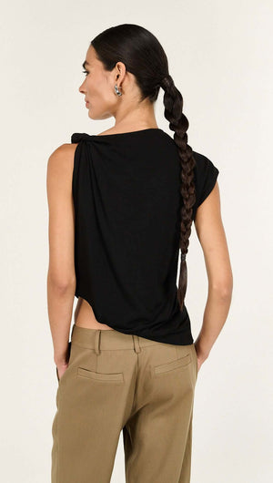 Model showcasing the back view of the Black Twist Asymmetric Tank, featuring a twist detail and draped silhouette.