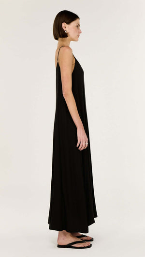 Side view of the graceful Black V-Neck Floaty Maxi Dress, emphasizing its elegant drape and minimalist design.