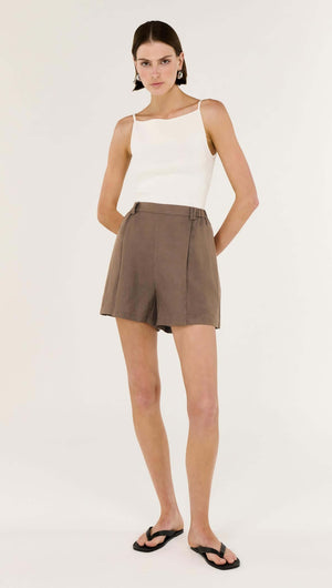 Brown Linen Blend High Waisted Shorts styled with a white tank top and sandals, showcasing a relaxed silhouette.