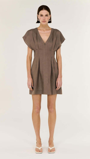 Model wearing a Brown Linen Blend Pleated Mini Dress with a deep V neckline and cap sleeves.