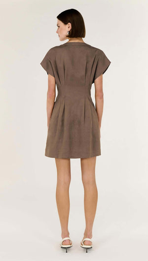 Back view of a woman wearing a Brown Linen Blend Pleated Mini Dress with cap sleeves and structured fit.