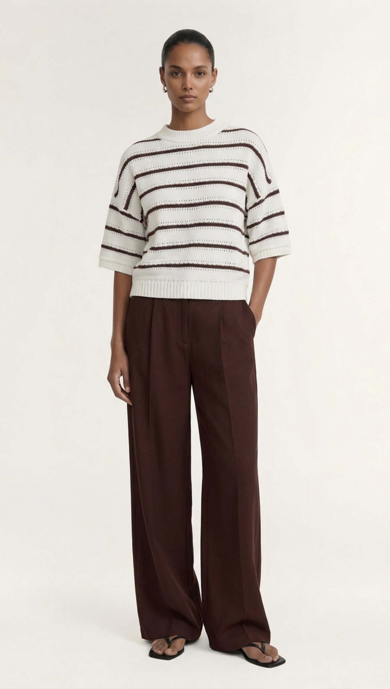 Brown Stripe Cotton Blend Crew Knit Tee worn with wide-leg brown pants, showcasing stylish and relaxed layering.