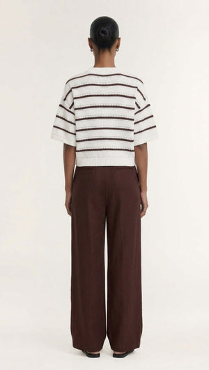 Back view of the Brown Stripe Cotton Blend Crew Knit Tee styled with wide-leg pants.
