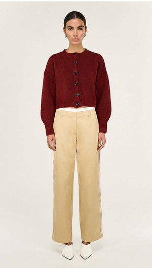 Burgundy Cropped Knit Cardigan styled with beige wide-leg pants and pointed white heels.