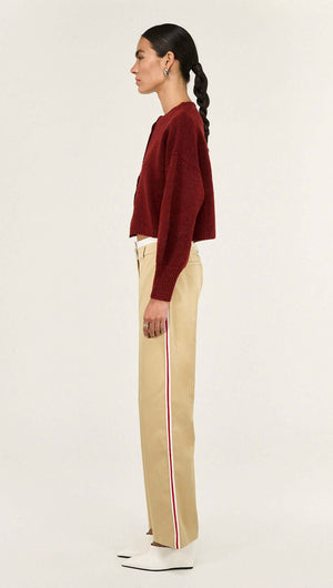Burgundy Cropped Knit Cardigan styled with beige trousers, showcasing a modern silhouette and plush texture.