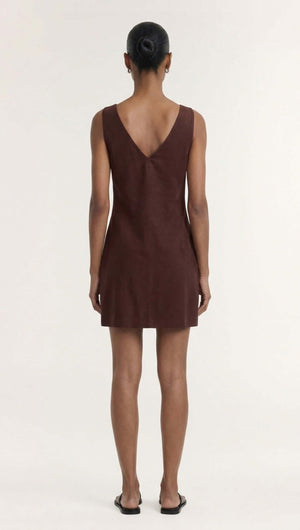 Back view of a model wearing the Chocolate Linen Blend Boat Neck Mini Shift Dress in rich chocolate hue.