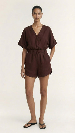 Model wearing a Chocolate Linen Blend Wrap Playsuit with a plunging neckline and elasticated waist.