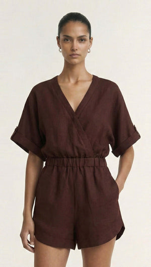 Model wearing a Chocolate Linen Blend Wrap Playsuit featuring dolman sleeves and an elasticated waist in a rich brown hue.