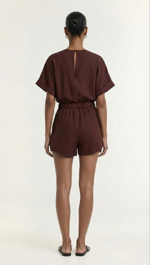Back view of a model wearing the Chocolate Linen Blend Wrap Playsuit showcasing its relaxed fit and stylish design.