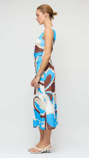 Side view of a woman wearing a Blue Abstract Mesh Midi Dress with an asymmetric shoulder and unique print.