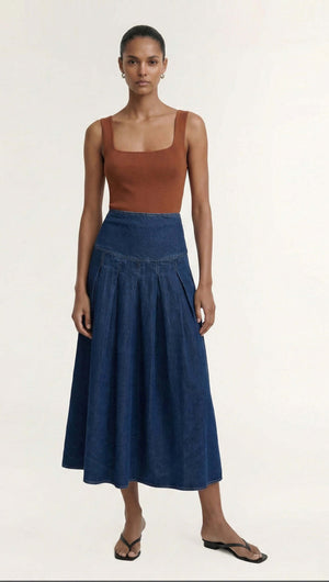 Model wearing a Copper Square Neck Ribbed Knit Tank with a denim skirt and sandals, showcasing modern style.