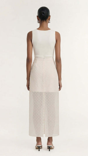 Back view of a woman wearing a Cream Embroidered Spot Sheer Layered Midi Skirt, showcasing the elegant layered design.