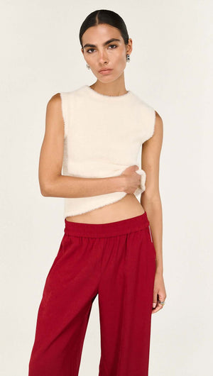 Model wearing the Cream Fluffy Knit Tank paired with red pants, showcasing its soft texture and sleeveless design.