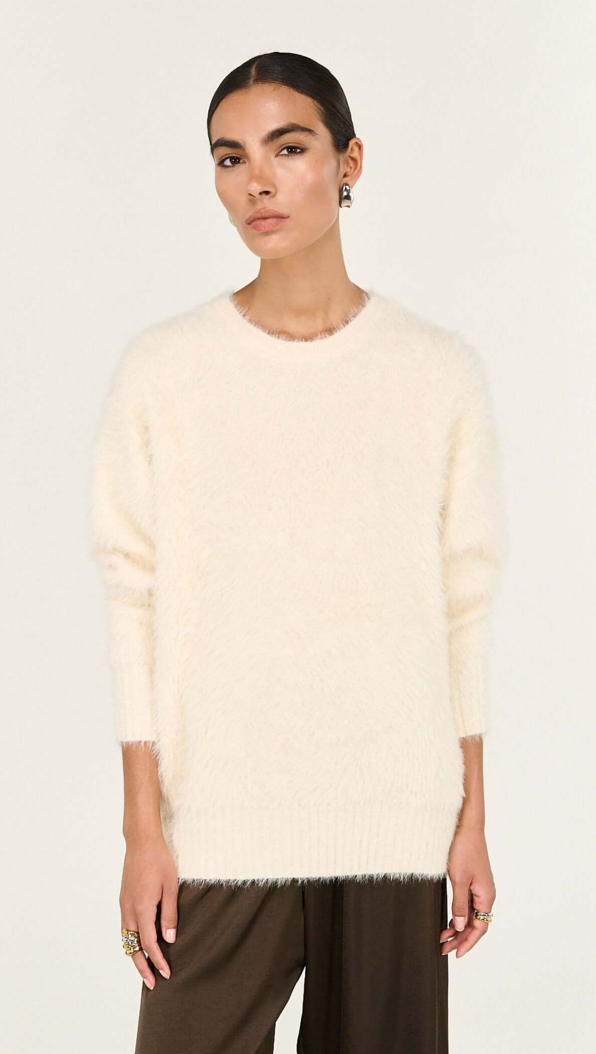 Cream Fluffy Oversized Jumper worn by a model, showcasing its soft texture and relaxed fit.