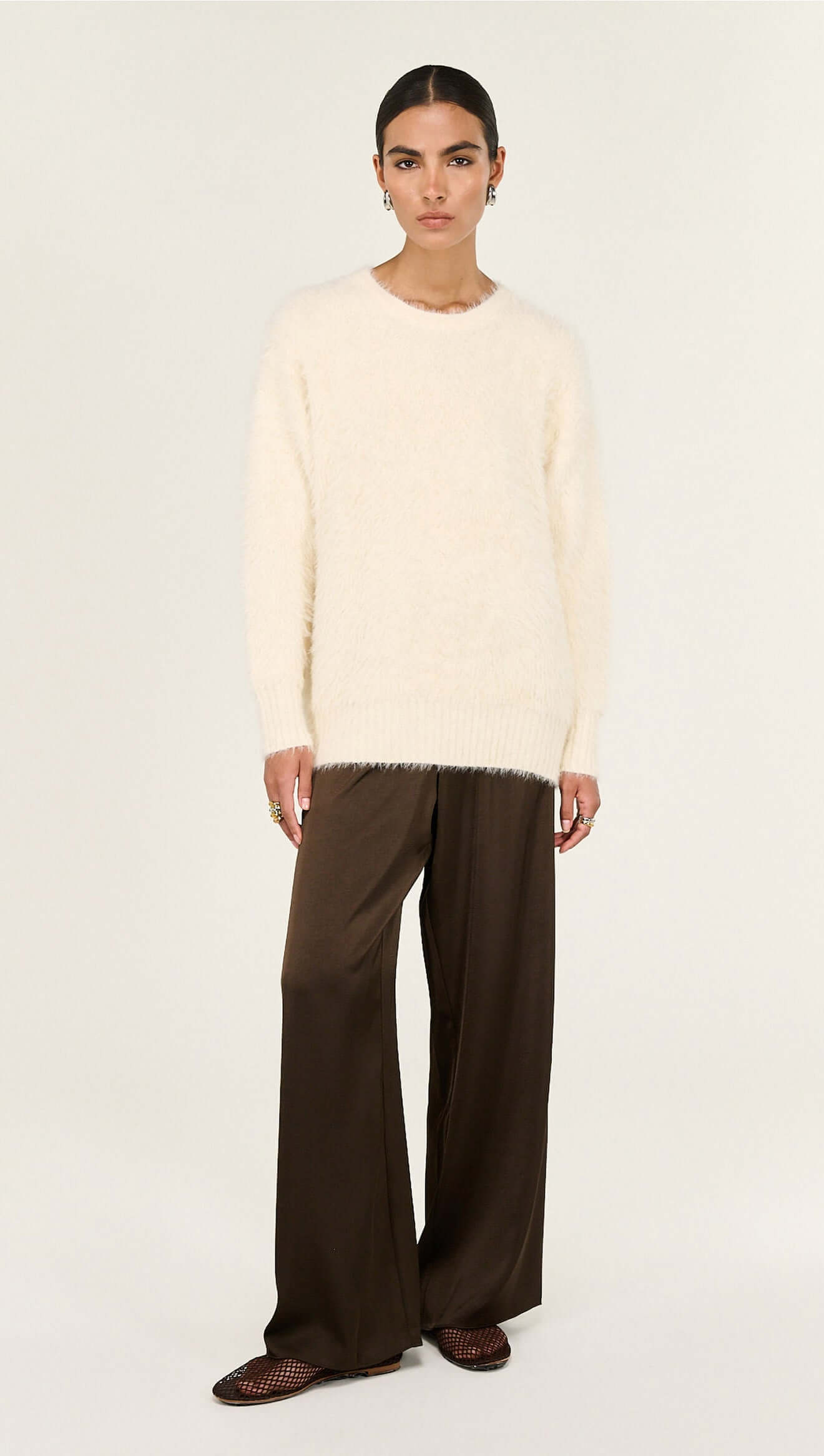 Cream Fluffy Oversized Jumper worn by a model, showcasing its soft texture and relaxed fit.