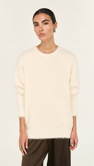 Cream Fluffy Oversized Jumper worn by a model, showcasing its soft texture and relaxed fit.