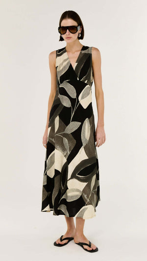 Model wearing the Dark Leaf Bias Midi Dress featuring a V-neckline and leaf print design.