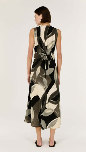 Back view of the Dark Leaf Bias Midi Dress showcasing its adjustable tie-back detail and elegant leaf print.