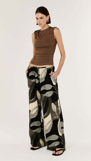 Model wearing the Dark Leaf Relaxed Wide-Leg Pant with a brown top, showcasing a stylish and comfortable outfit.