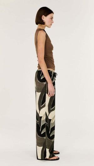 Model showcasing the Dark Leaf Relaxed Wide-Leg Pant in Leaf Garden print, featuring a side view for styling inspiration.