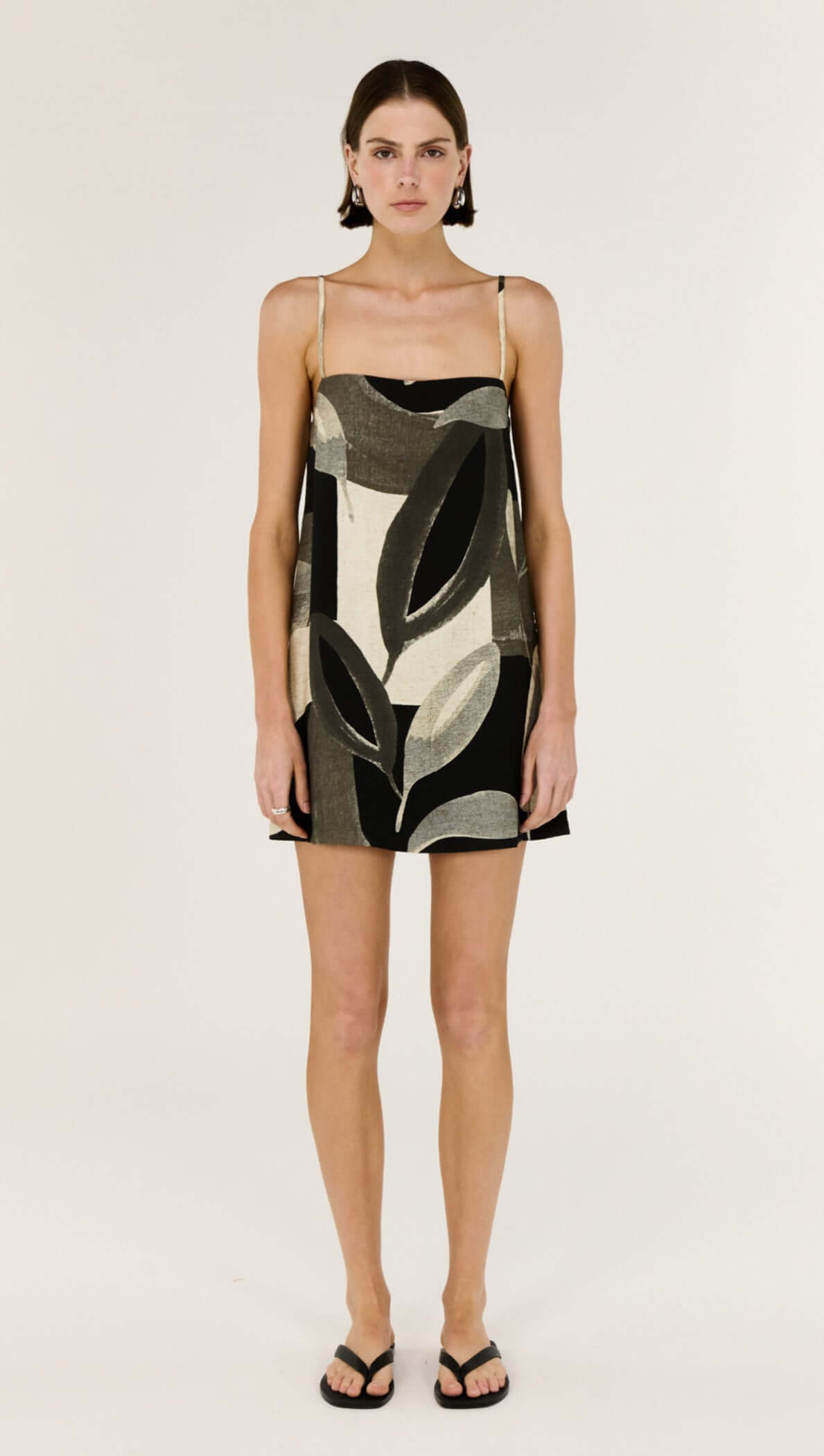 Model wearing the Dark Leaf Shift Mini Dress with a relaxed trapeze silhouette and statement Leaf Garden print.