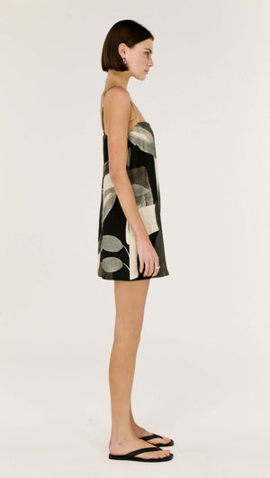 Side view of the Dark Leaf Shift Mini Dress showcasing its relaxed trapeze silhouette and leaf garden print.