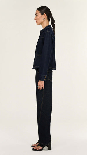A model showcases the Dark Wash Straight Leg Jeans alongside a matching jacket, exemplifying stylish denim wear.