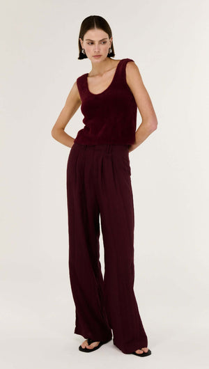 Model wearing Deep Red Textured Wide-Leg Pant with a stylish tank top, showcasing relaxed fashion.