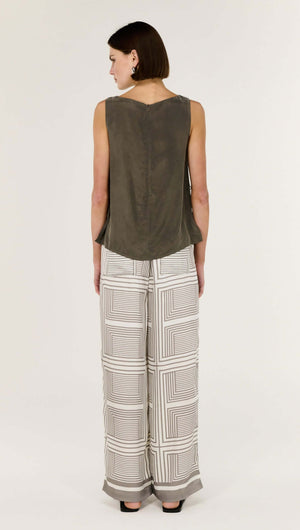 Back view of a woman wearing Geometric Print Relaxed Wide-Leg Low Rise Pant paired with a sleeveless top.