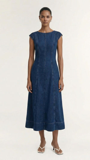 Indigo Chambray Panelled Midi Dress styled on a model, showcasing its fitted and flared silhouette in a rich indigo wash.