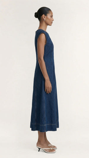 Side view of a model wearing the Indigo Chambray Panelled Midi Dress, showcasing its fitted-and-flared silhouette.