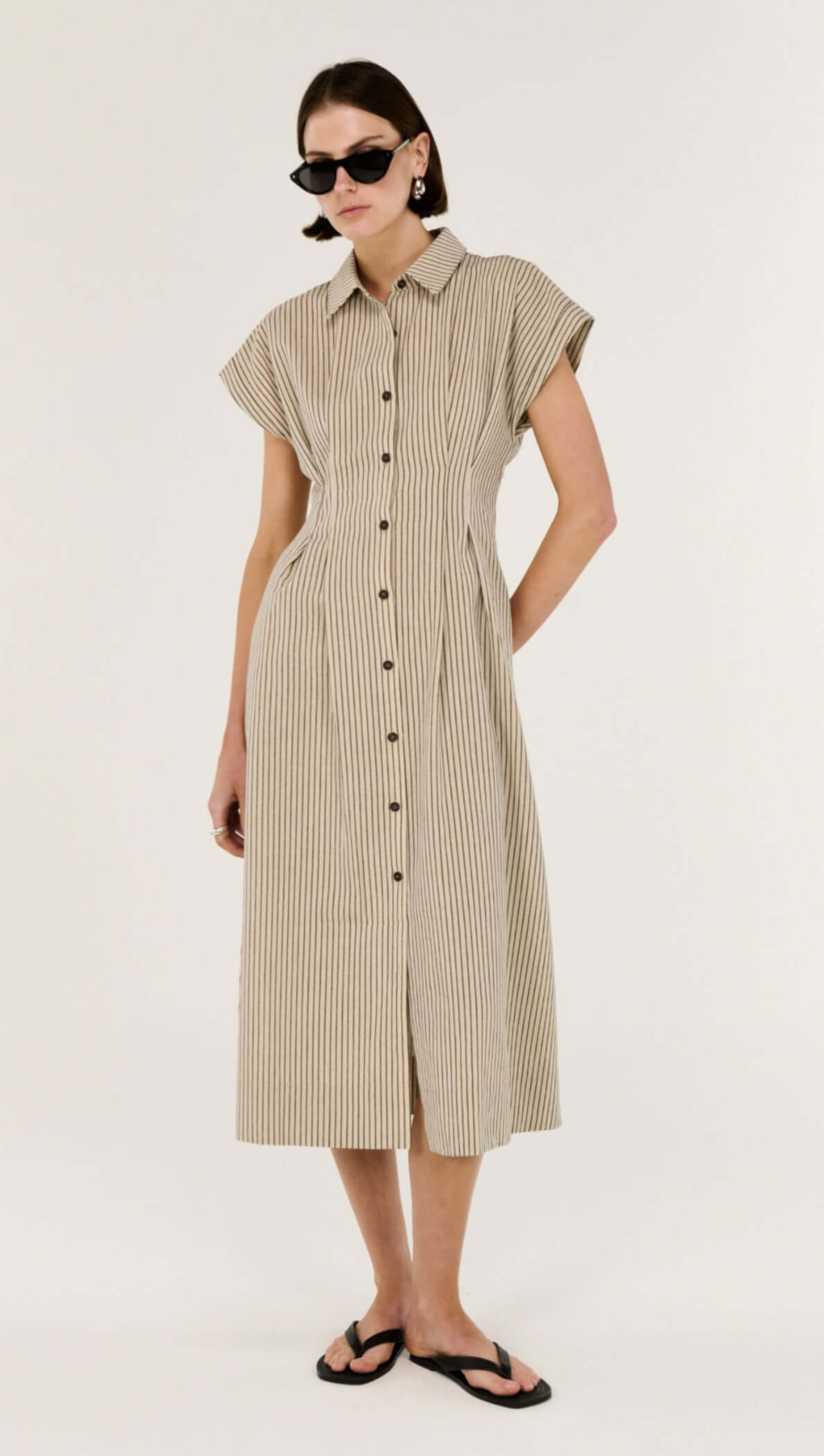 Linen Blend Pinstripe Midi Shirt Dress displayed on a model wearing sunglasses and flip flops, showcasing its classic design and silhouette.