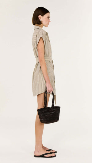 Model wearing a Linen Blend Pinstripe Mini Shirt Dress with a structured collar, holding a black handbag.