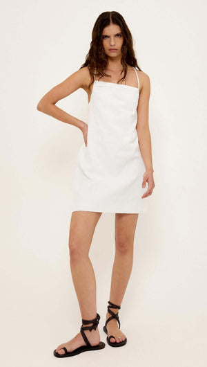 Linen Cotton Blend White Mini Dress on model with relaxed A-line fit and adjustable tie-back straps.