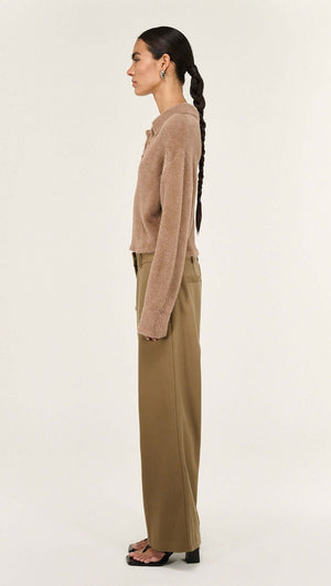 Mocha Fluffy Knit Polo Jumper showcased on a model from the side, highlighting its relaxed silhouette and polo collar.